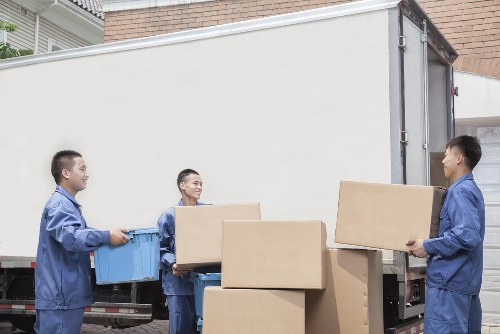 Small removals van loading furniture in Woodford