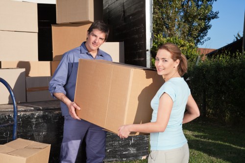 Organised storage unit with boxes and furniture in Woodford